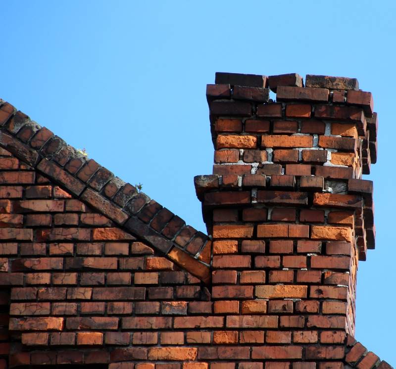 Signs Your Lawrence Home Needs a Chimney Inspection Damaged chimney on an Lawrence home showing cracks and missing mortar